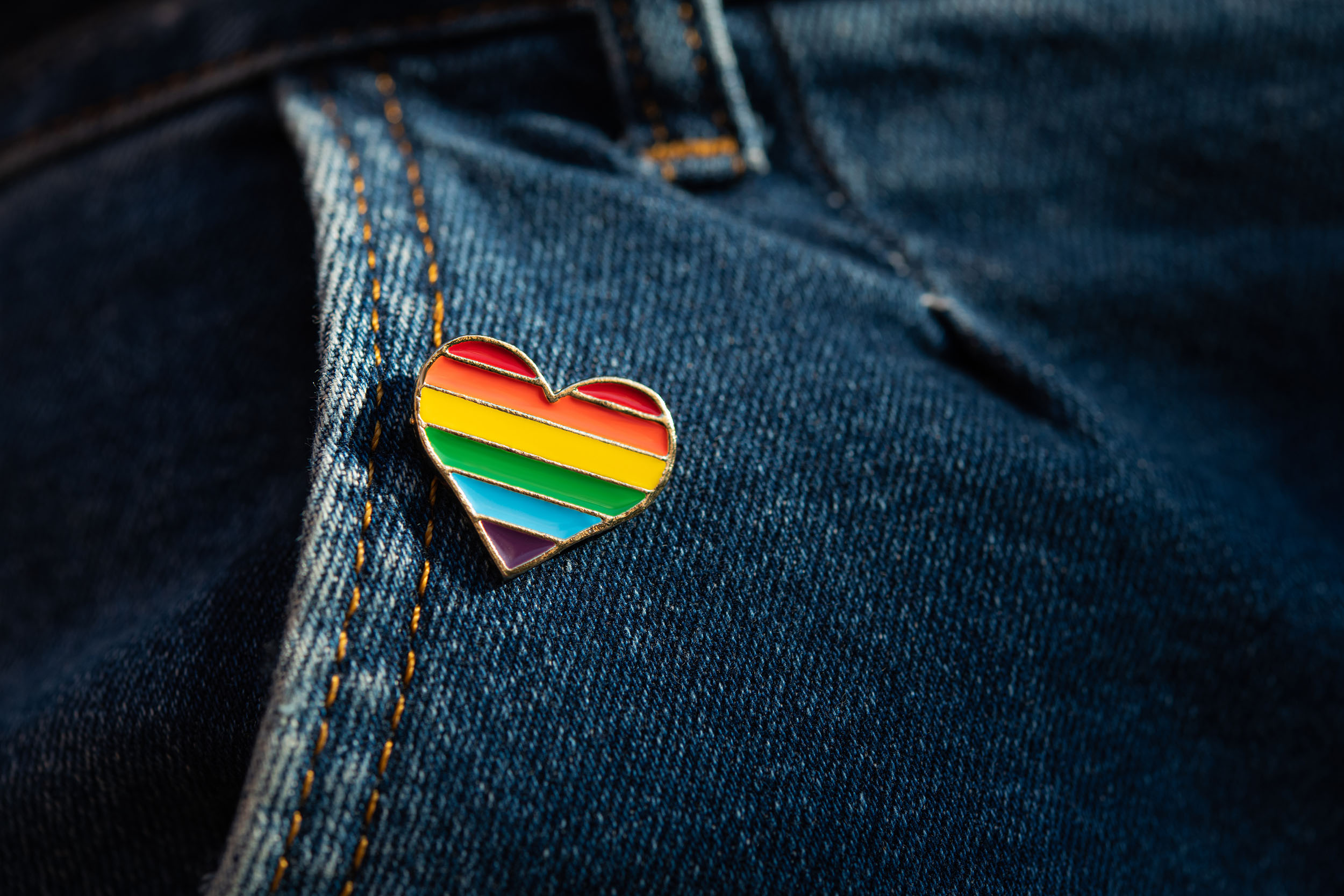 Rainbow color lgbt heart badge on jeans.
