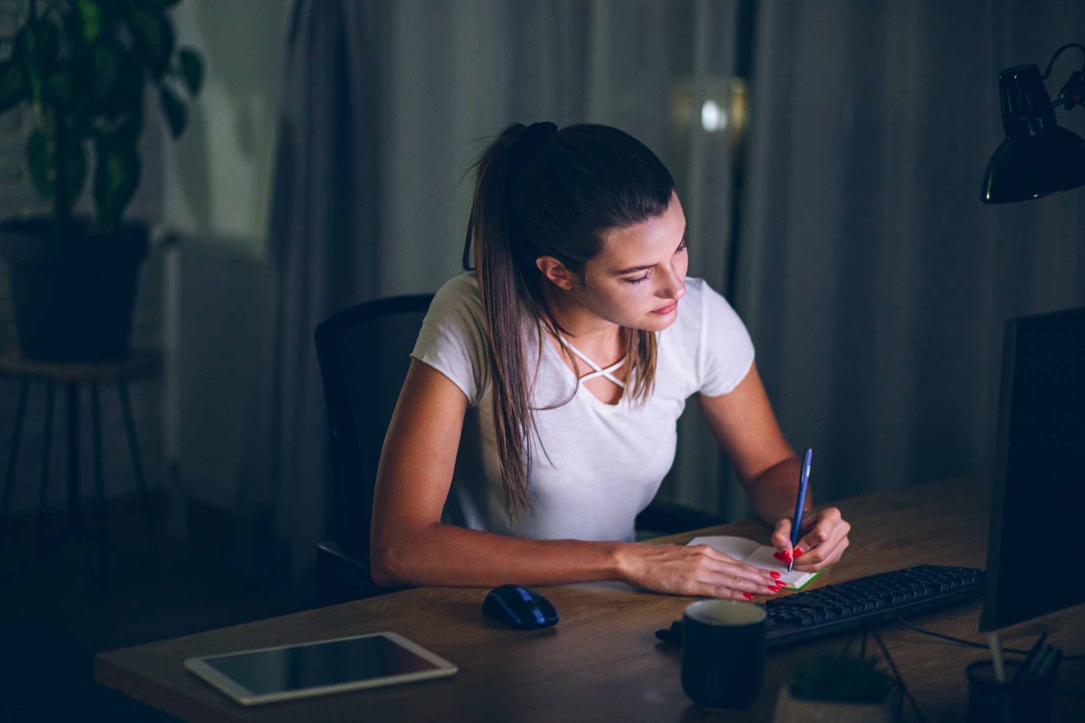 Young woman studying late at night for an exam