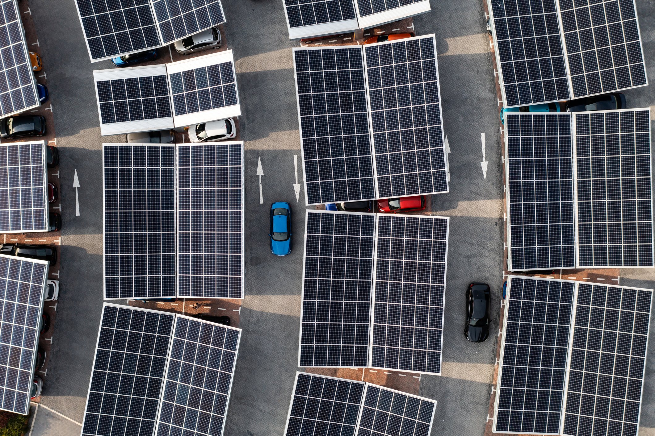 Aerial view of solar panels on a parking lot rooftop