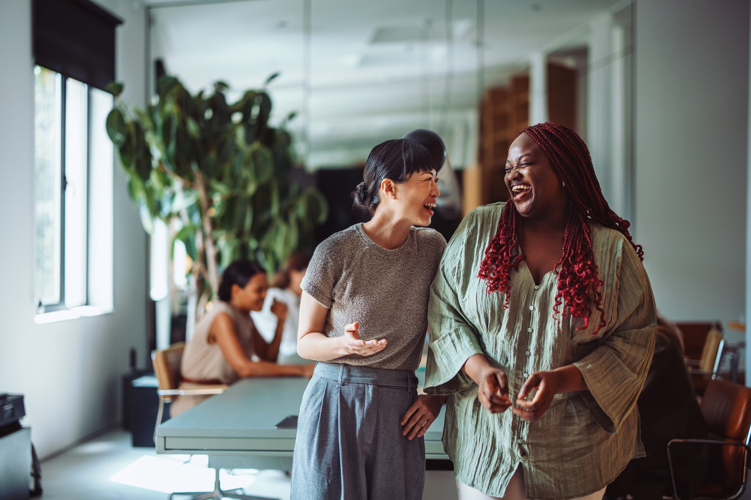 Coworkers Laughing Together During Office Break